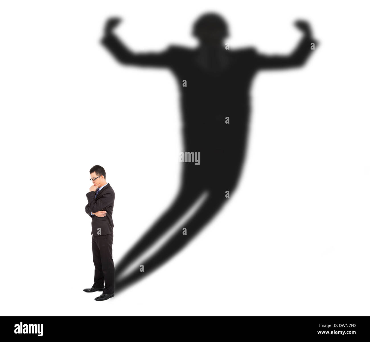 Business man standing and casting shadow of a strong man on white background Stock Photo