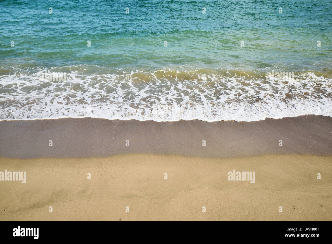 sandy beach with sea spray Stock Photo