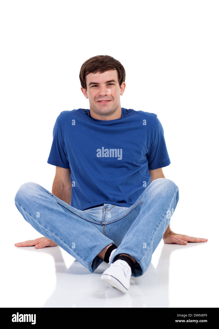 smiling man sitting on the floor isolated on white Stock Photo - Alamy