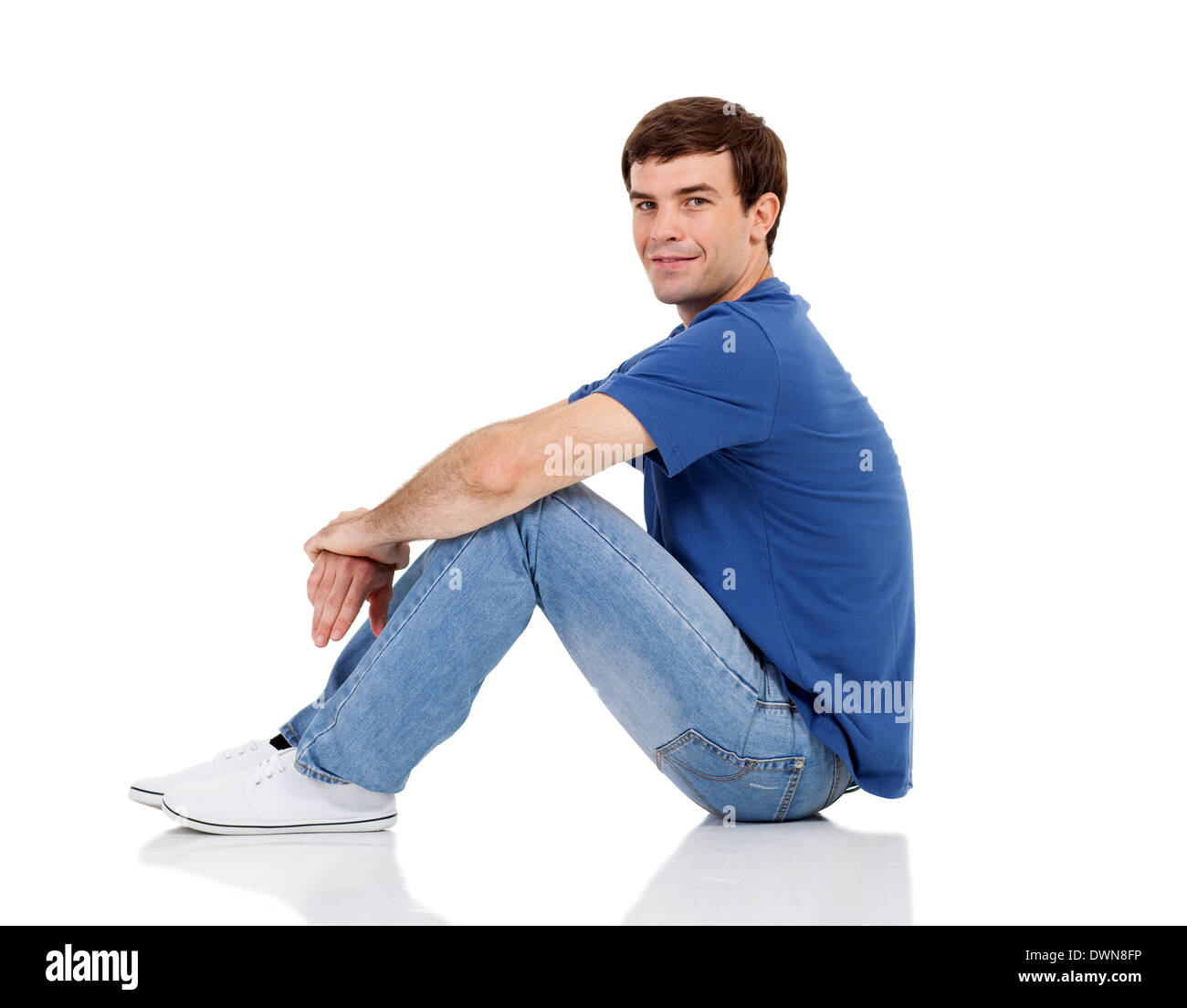 side view of handsome man sitting on the floor isolated on white Stock Photo