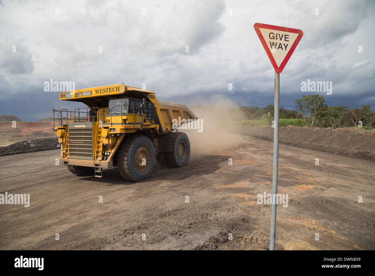 150Ton Komatsu mining truck with a give way sign in a large african open cast copper mine Stock Photo