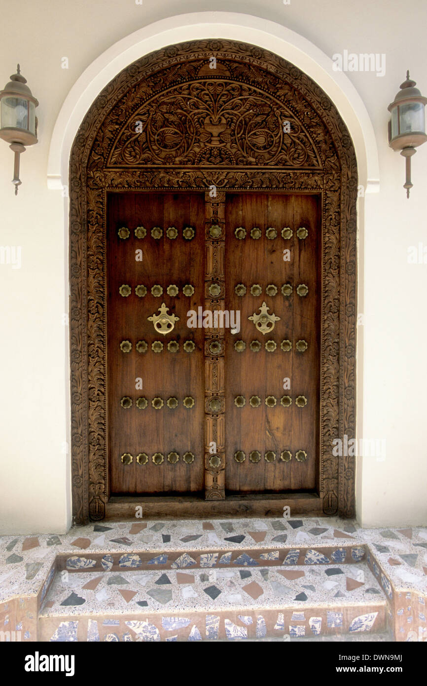 Ornate carved wooden door, famous in historic Stone Town, Zanzibar, Tanzania, Africa Stock Photo