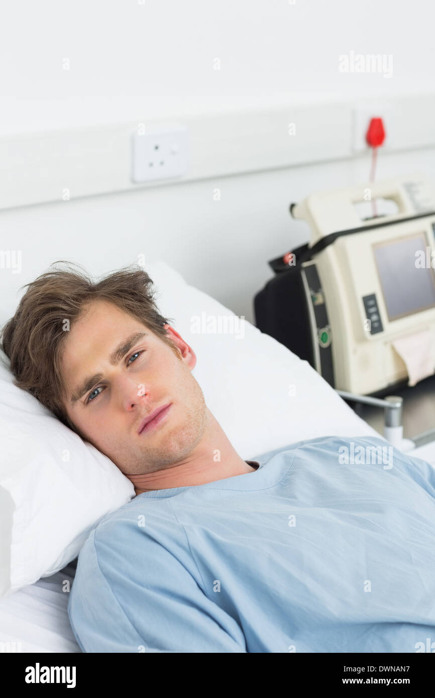 Sick man lying in hospital bed Stock Photo Alamy