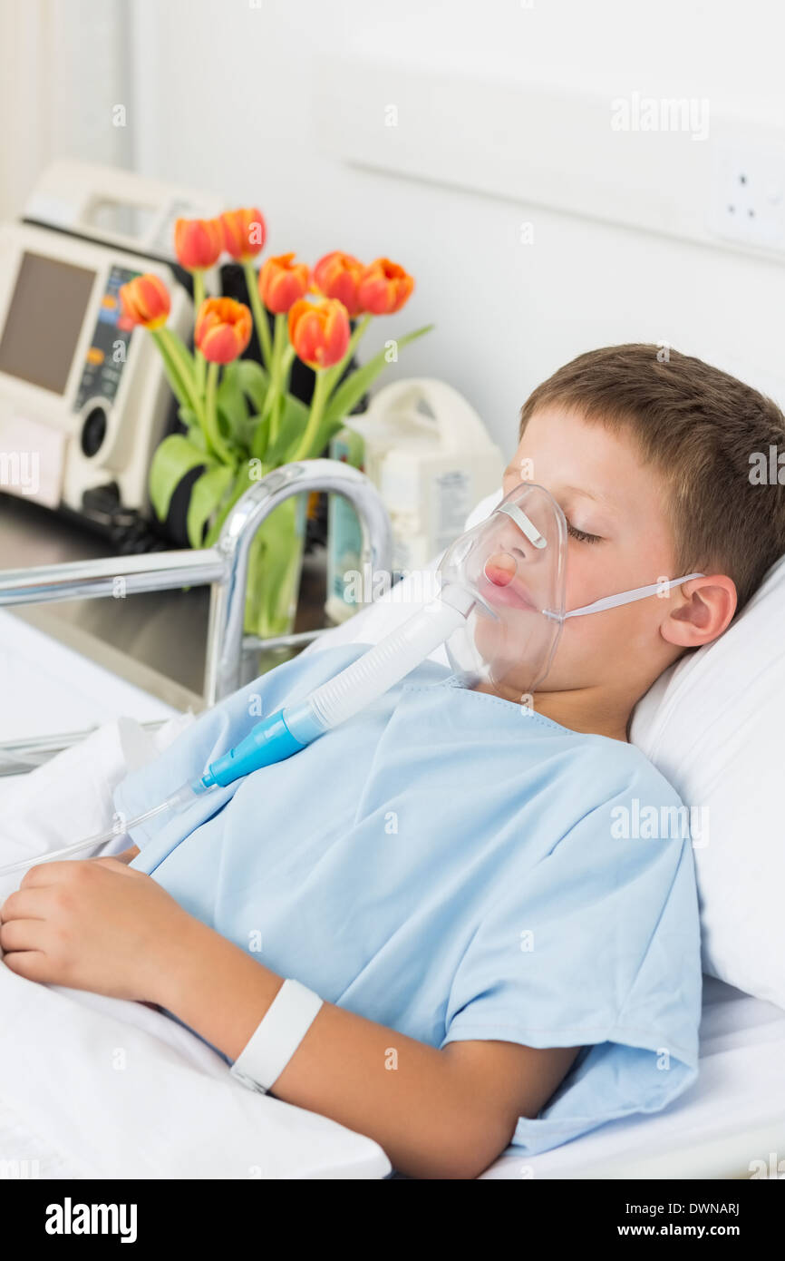 Boy wearing oxygen mask in hospital bed Stock Photo Alamy