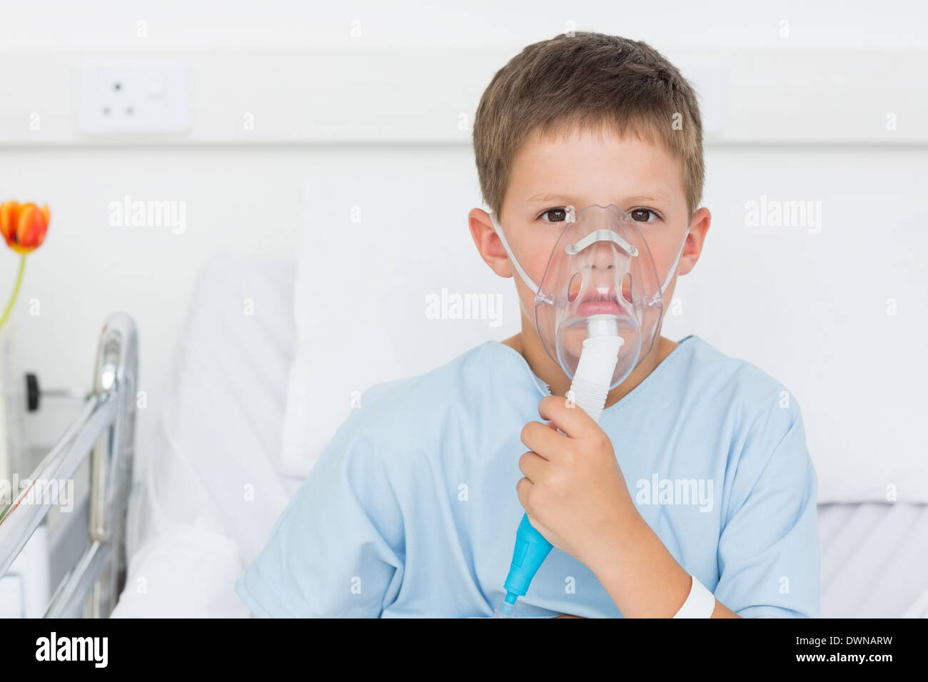 Boy wearing oxygen mask in hospital bed Stock Photo Alamy