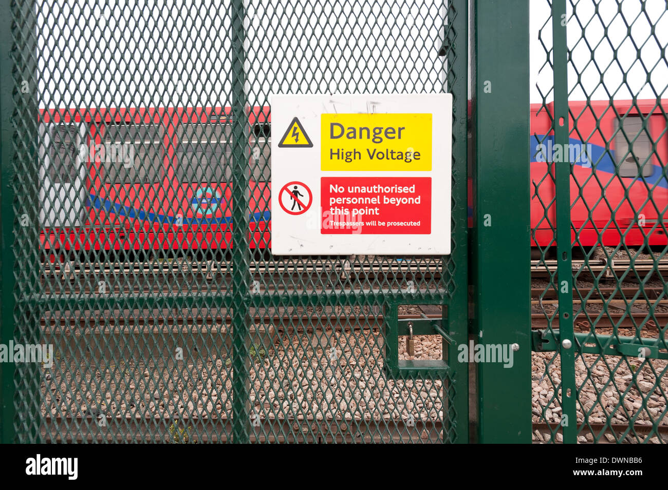 Danger high voltage only safe railway crossing is a closed one risk of  electrocution security fencing DLR trainline Stock Photo - Alamy