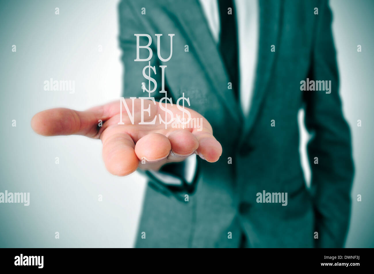 a businessman showing the word business in his hand written with dollar signs instead of esses Stock Photo
