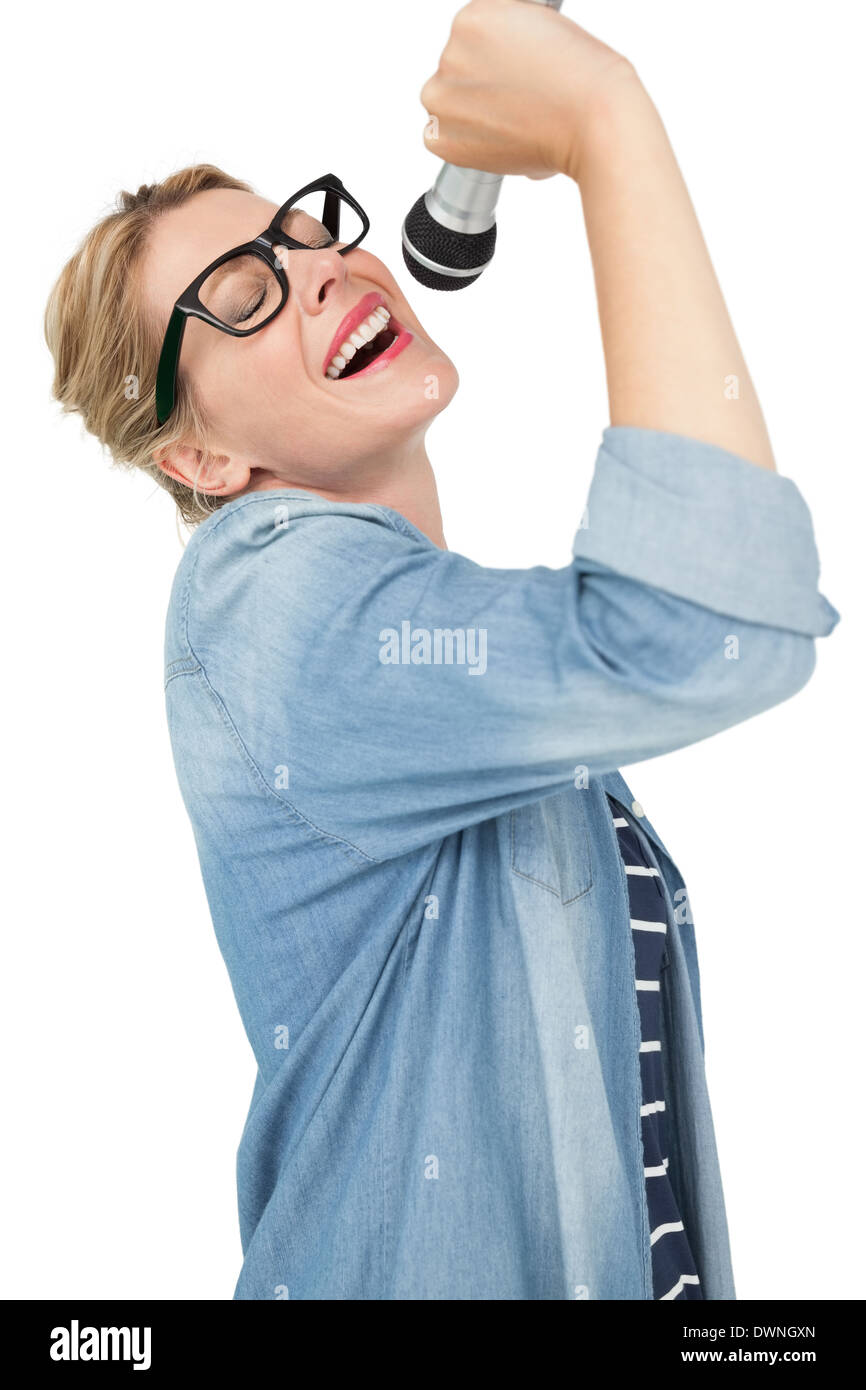 Beautiful young woman singing into a microphone Stock Photo Alamy
