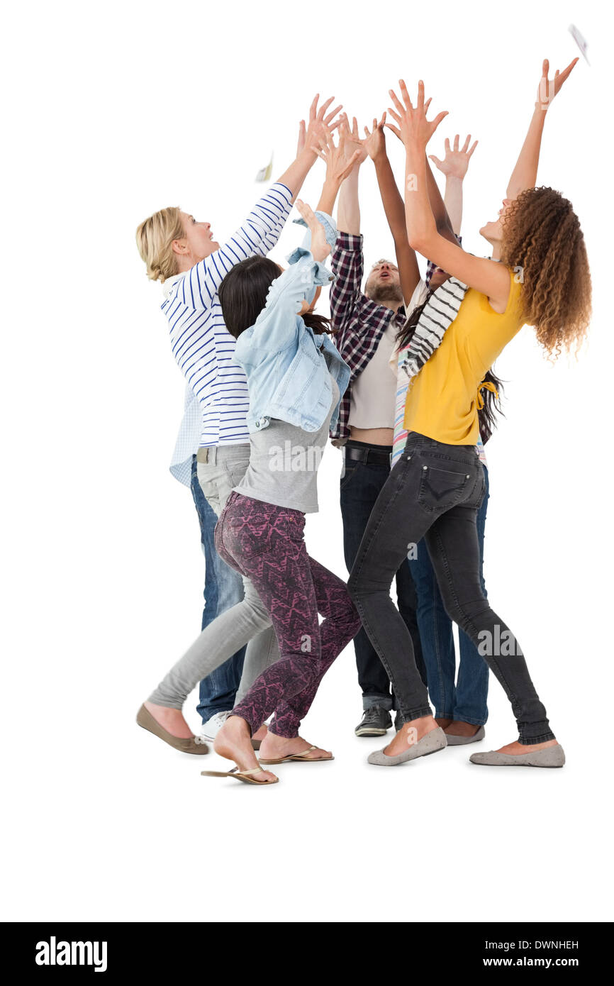 Casually dressed happy young people raising hands Stock Photo