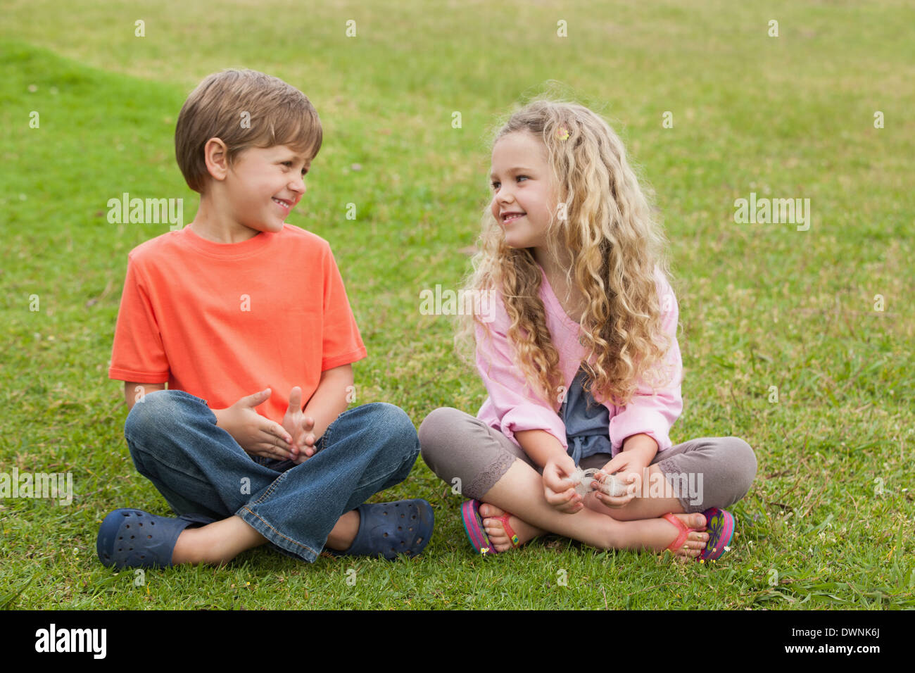 Smiling blonde girl sitting crossed hi-res stock photography and images ...