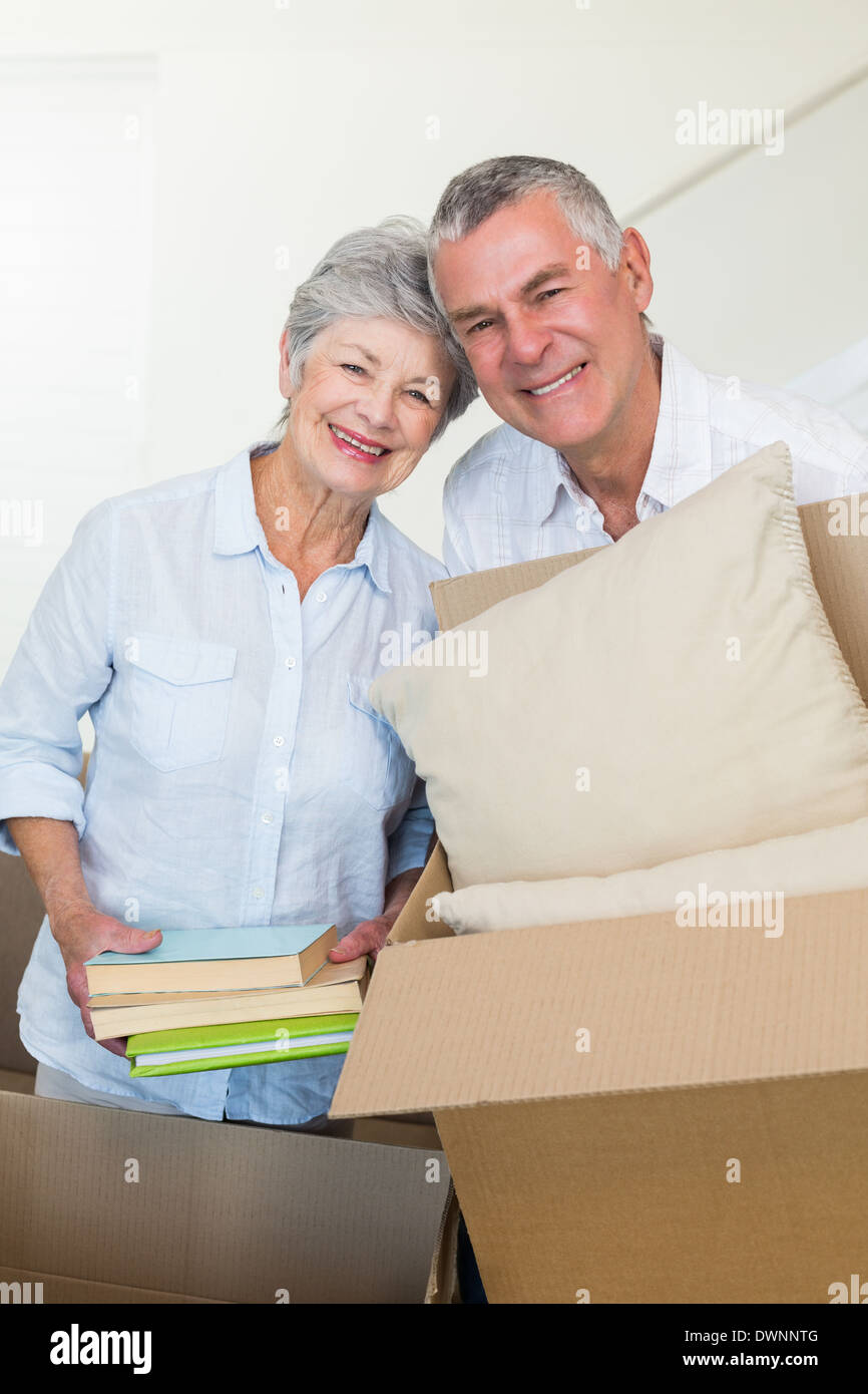 Happy senior couple moving into new home Stock Photo