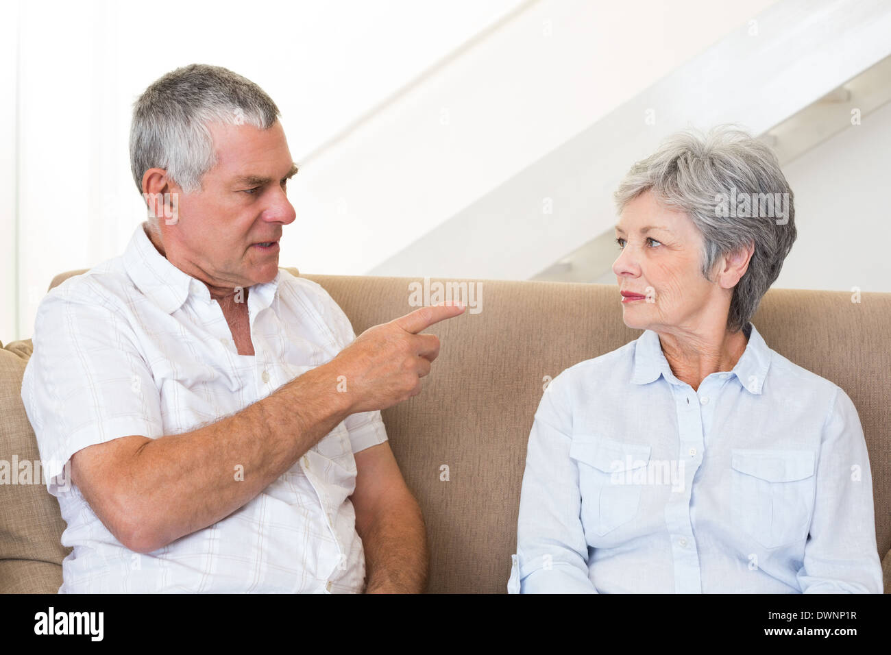 Senior couple sitting on couch having an argument Stock Photo - Alamy