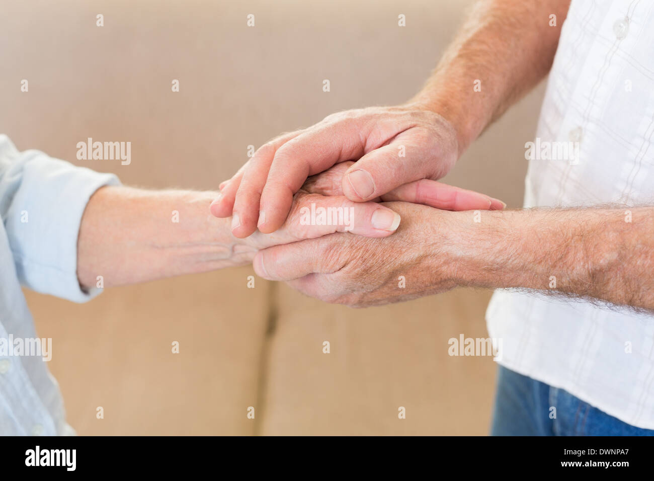 Retired couple touching hands Stock Photo
