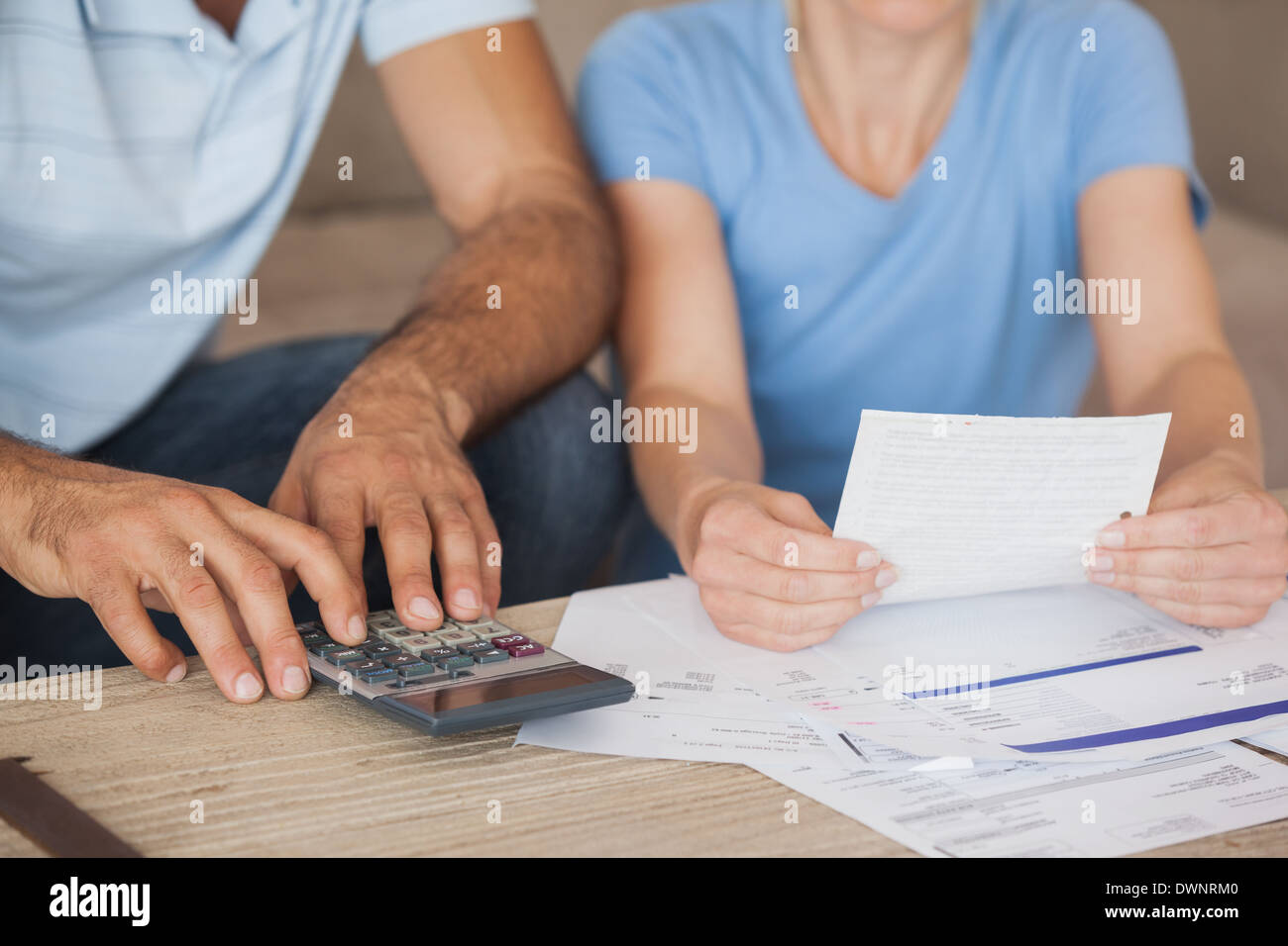 Mid section of a couple with bills and calculator Stock Photo Alamy