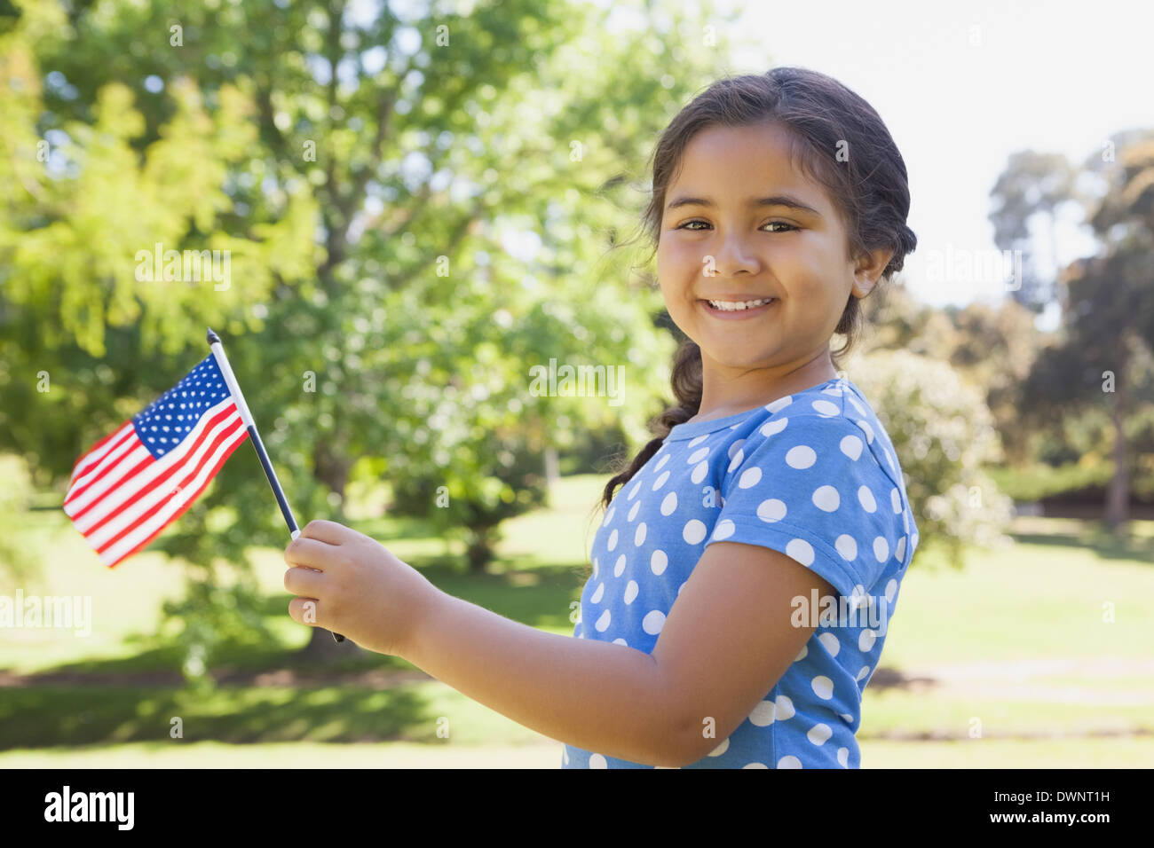 Girl holding the American flag at park Stock Photo - Alamy