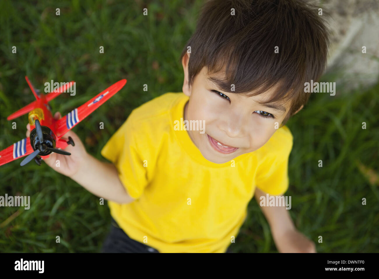 Young boy playing with a toy plane at park Stock Photo - Alamy