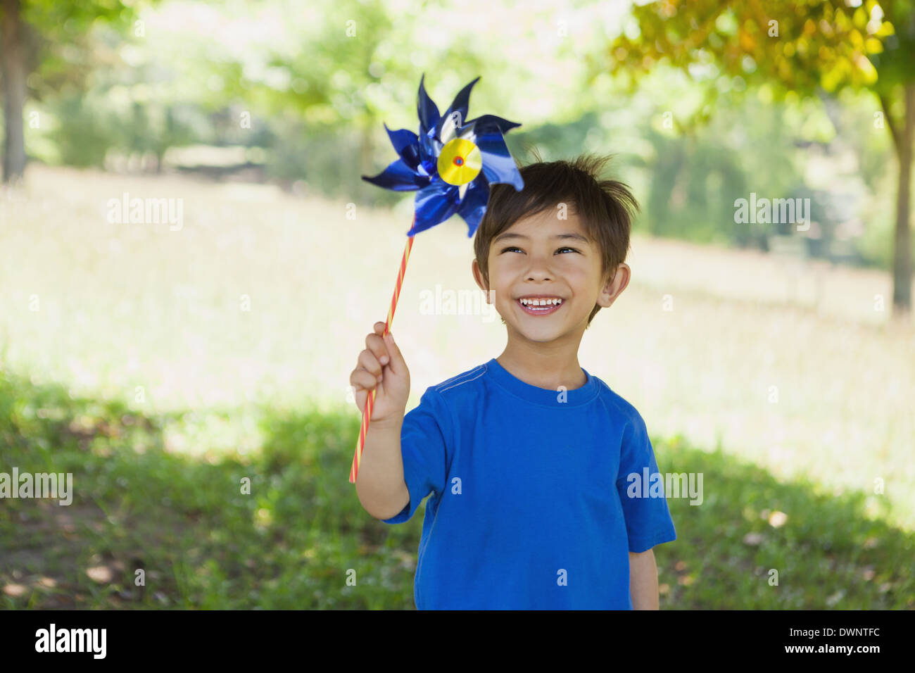 Happy cute little boy holding pinwheel at park Stock Photo - Alamy