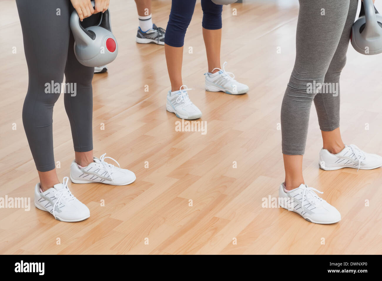Fit women exercising with kettlebells in the gym Stock Photo