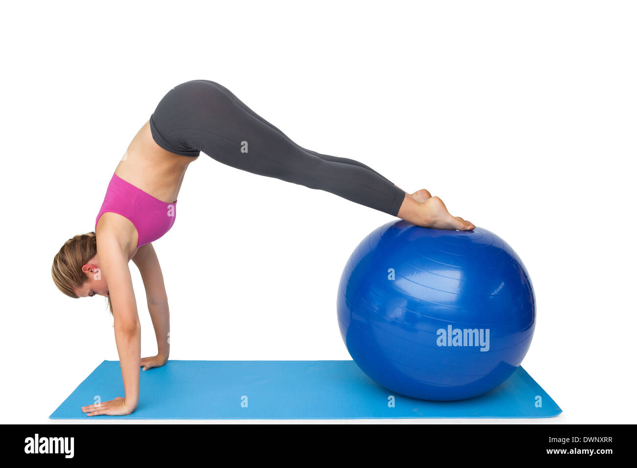 Side view of a fit woman stretching on fitness ball Stock Photo - Alamy