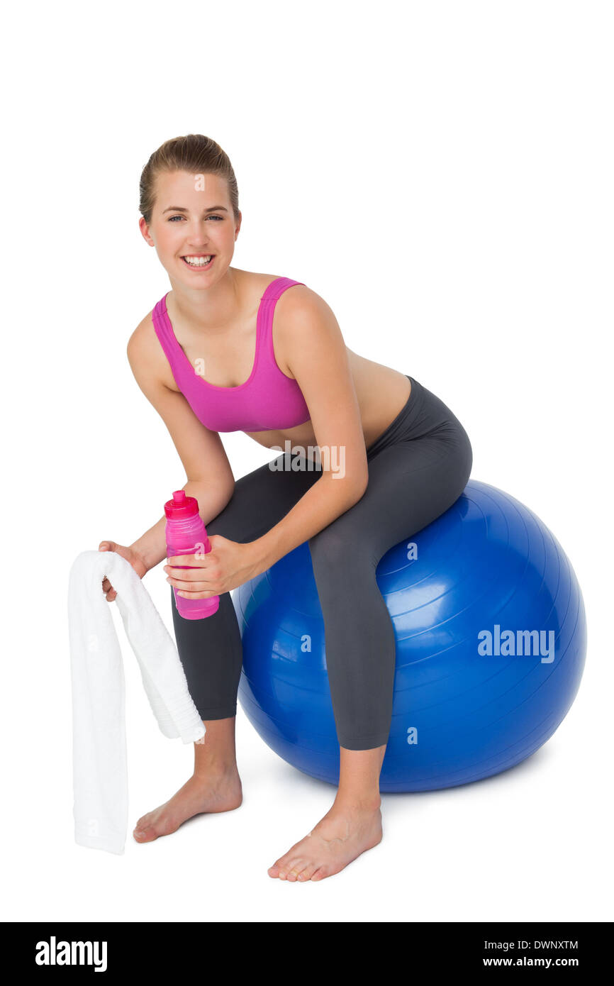 Portrait of a fit woman sitting on exercise ball Stock Photo - Alamy
