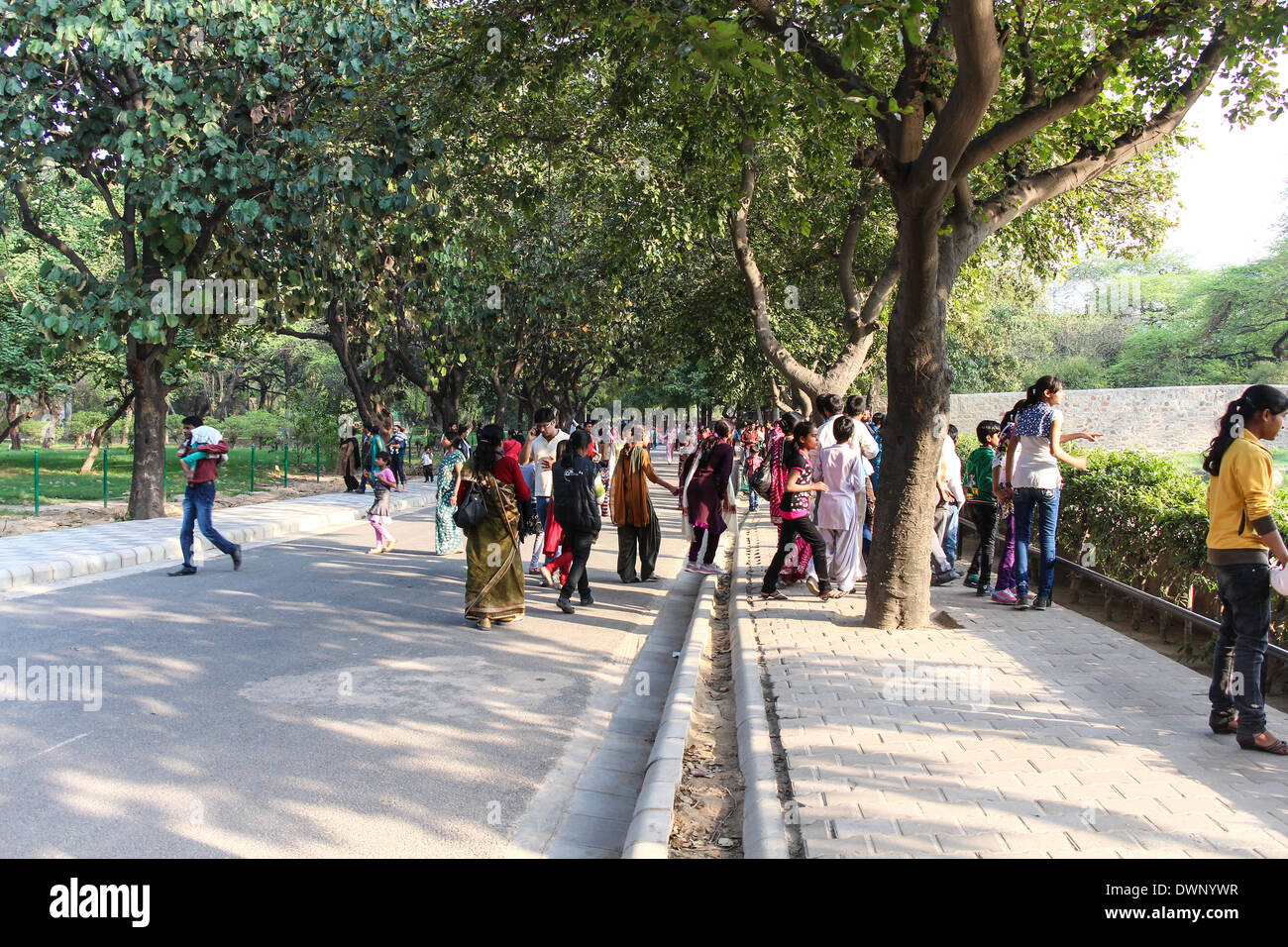 A large number of people inside Delhi zoo. This is the road right outside the exhibit for giraffes, with visitors watching Stock Photo