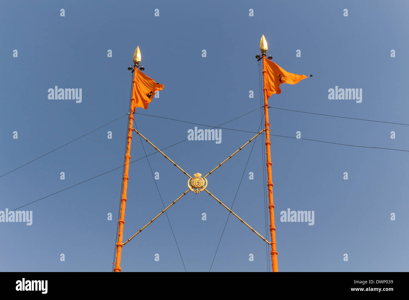 Top part of Nishan Sahib at Golden Temple in Amritsar, the holiest site for Sikhism. These are triangular flags on flagpoles Stock Photo