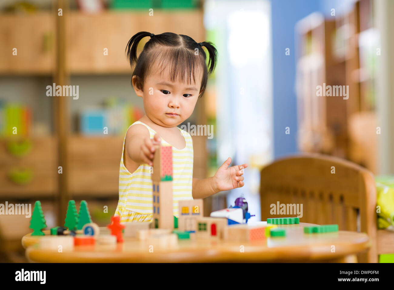 Little girl playing with toys at home Stock Photo - Alamy