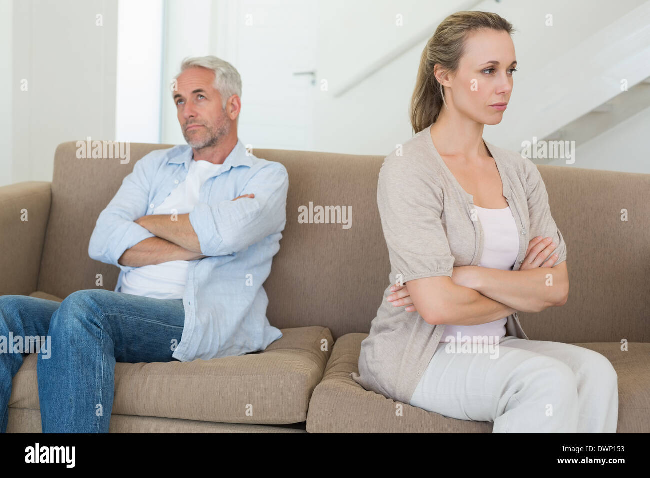 Angry couple sitting on couch not talking to each other Stock Photo - Alamy