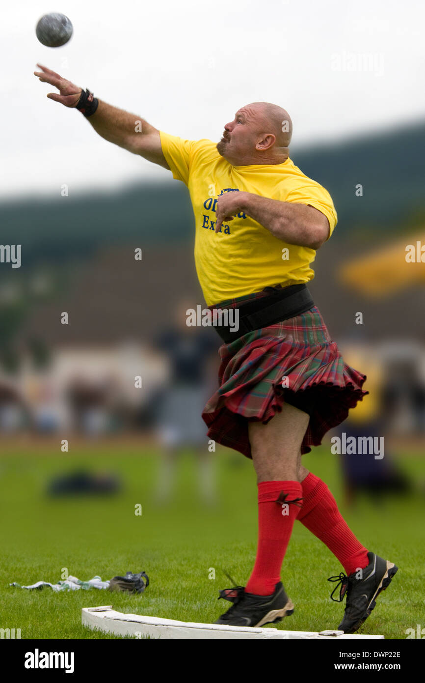 Sportsman 'Putting the shot' at the Cowal Gathering Highland Games near Dunoon on the Cowal Peninsula in Scotland. Stock Photo