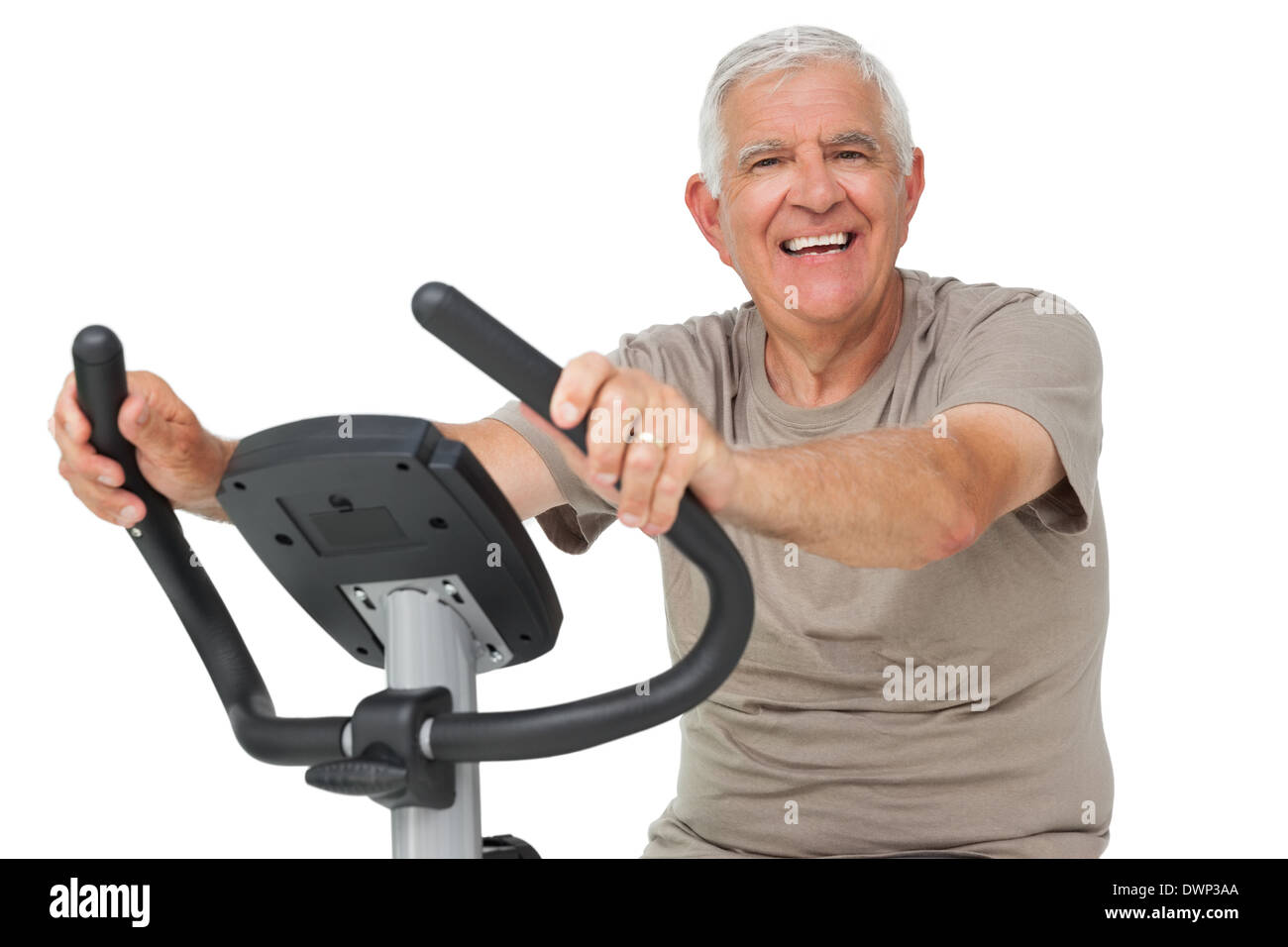 Portrait of a happy senior man on stationary bike Stock Photo