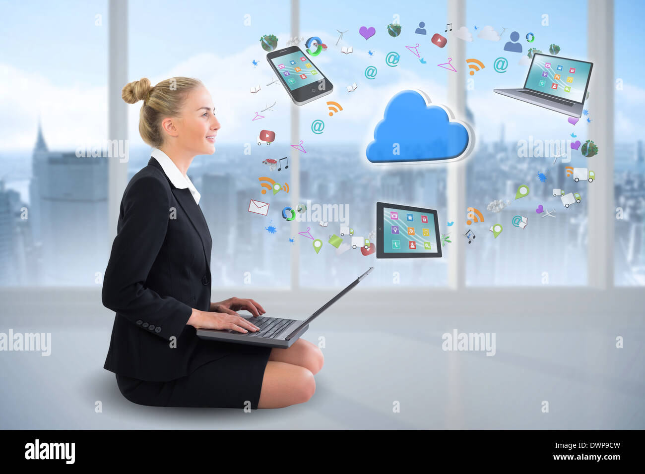 Blonde businesswoman sitting using laptop with cloud and app icons Stock Photo