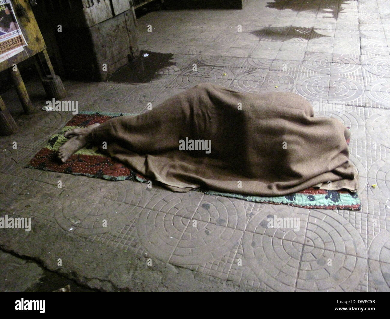 Streets of Kolkata, man sleeping on the streets of Kolkata,India on January 30, 2009. Stock Photo