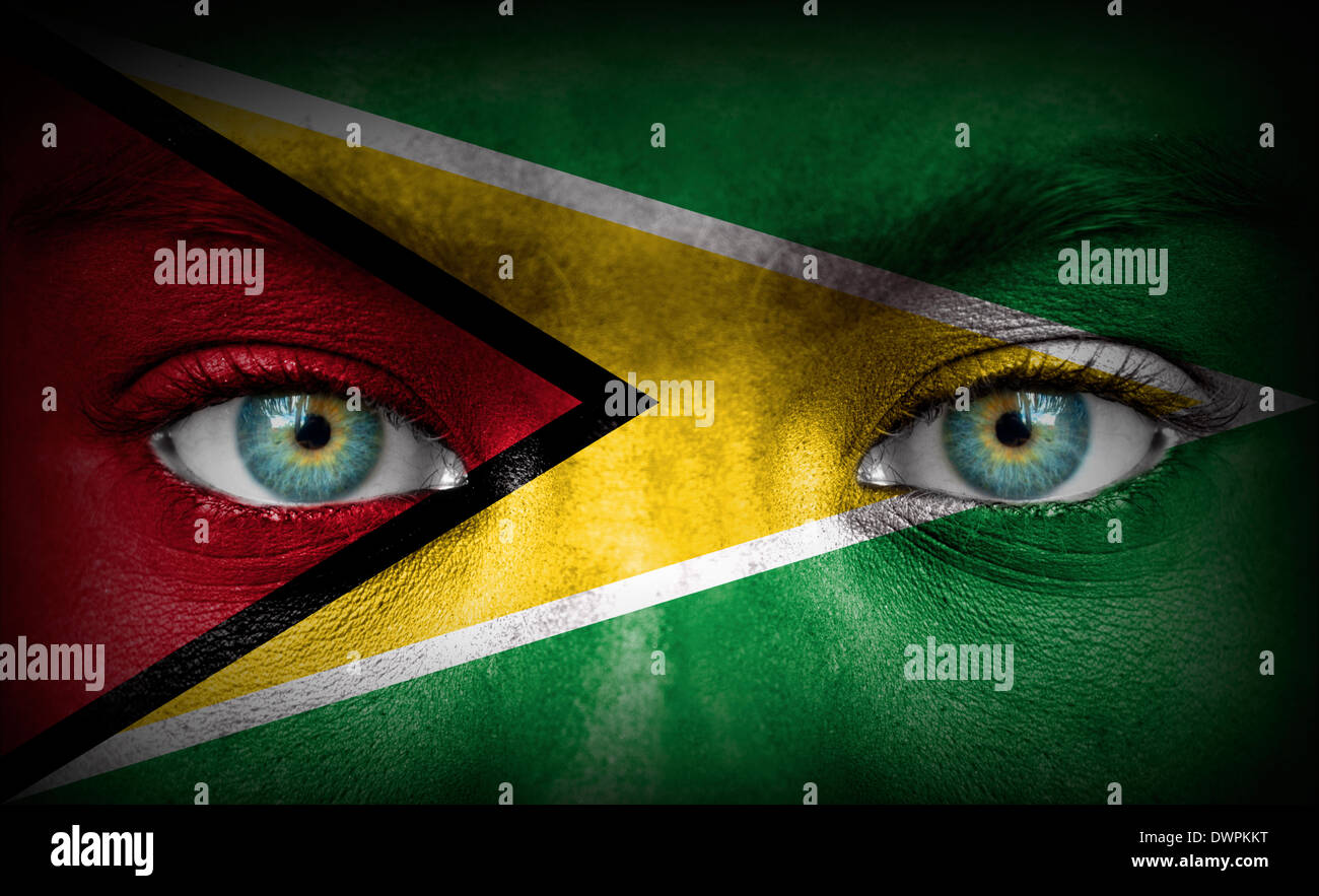 Human face painted with flag of Guyana Stock Photo