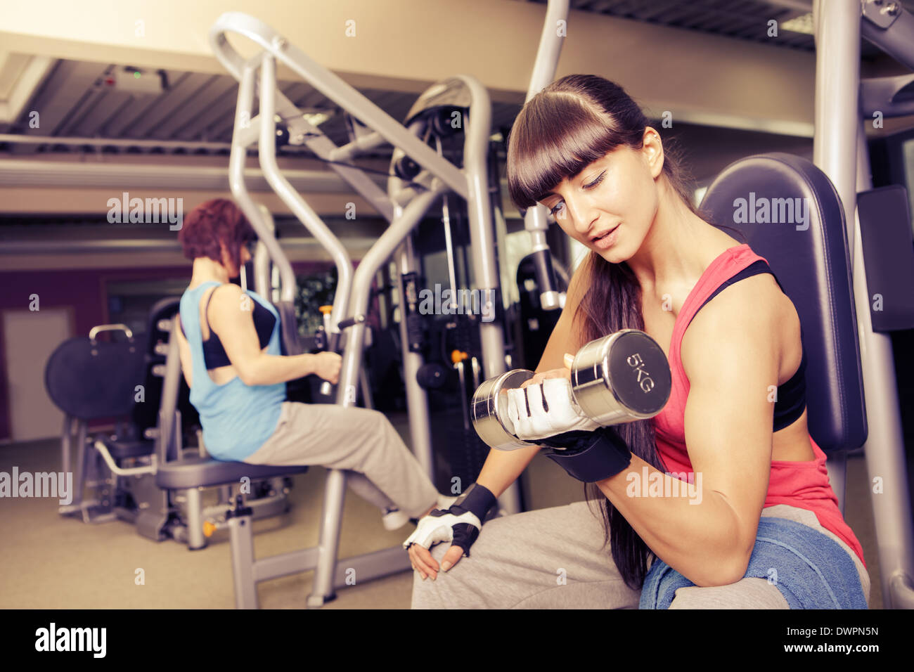 young woman in sport dress in a gym room Stock Photo