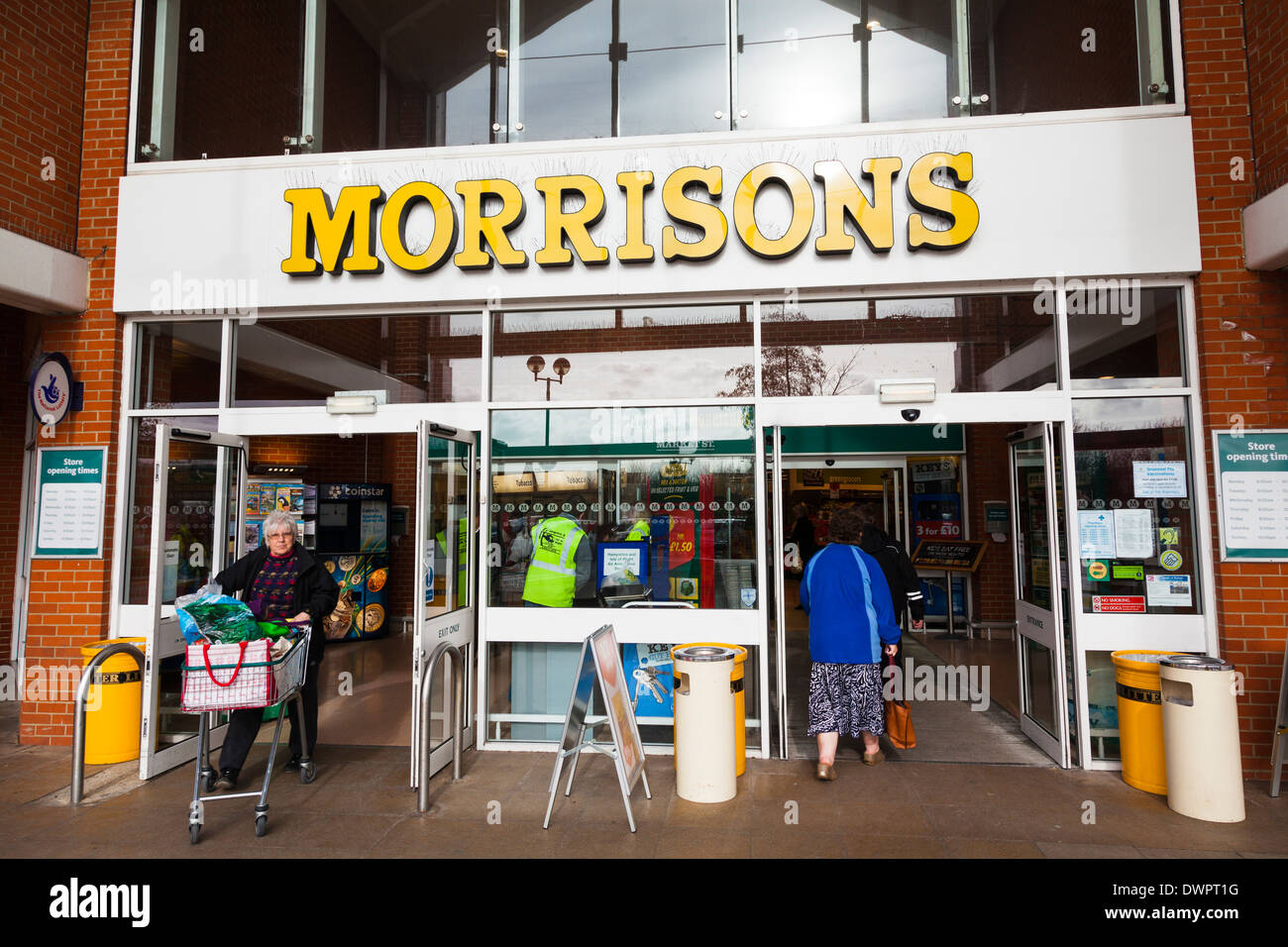 Customers entering and leaving a Morrisons Supermarket. Stock Photo