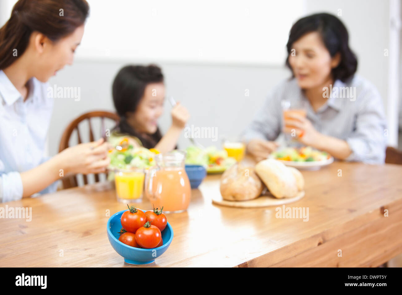 two women and a kid in the kitchen Stock Photo