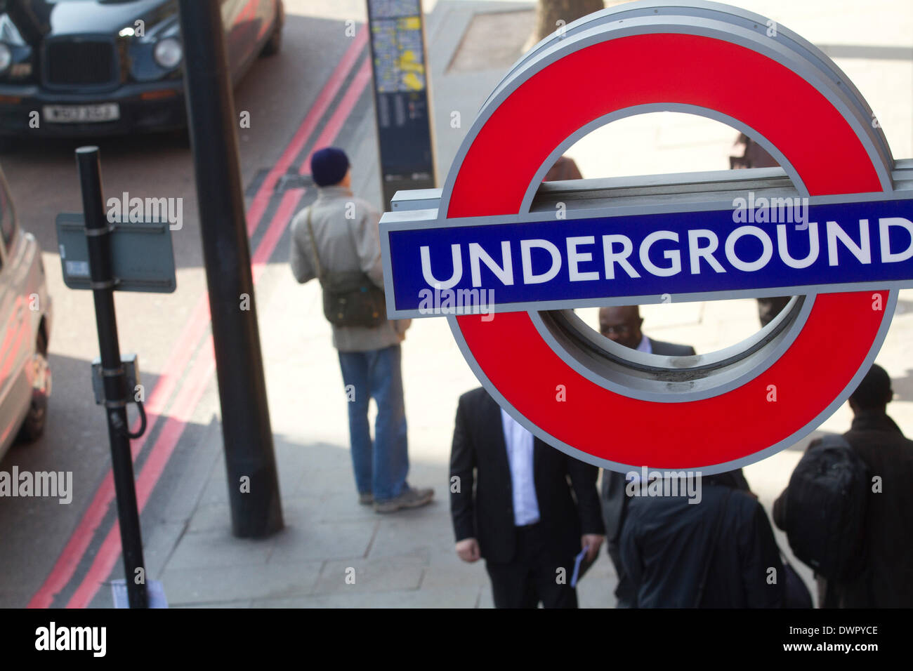 London UK. 12th March 2014. People walk under an Underground sign after the death of British trade union leader Bob Crow who died aged 52 on March 11th of a suspected heart attack. Bob Crow became General Secretary of the RMT in 2002. Credit:  amer ghazzal/Alamy Live News Stock Photo