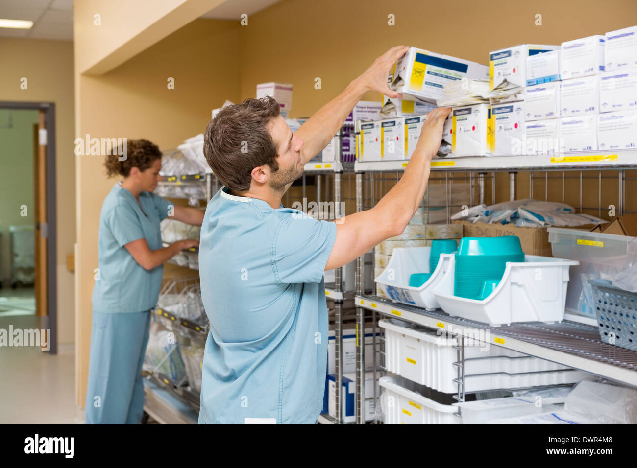 Nurses Arranging Stock In Storage Room Stock Photo