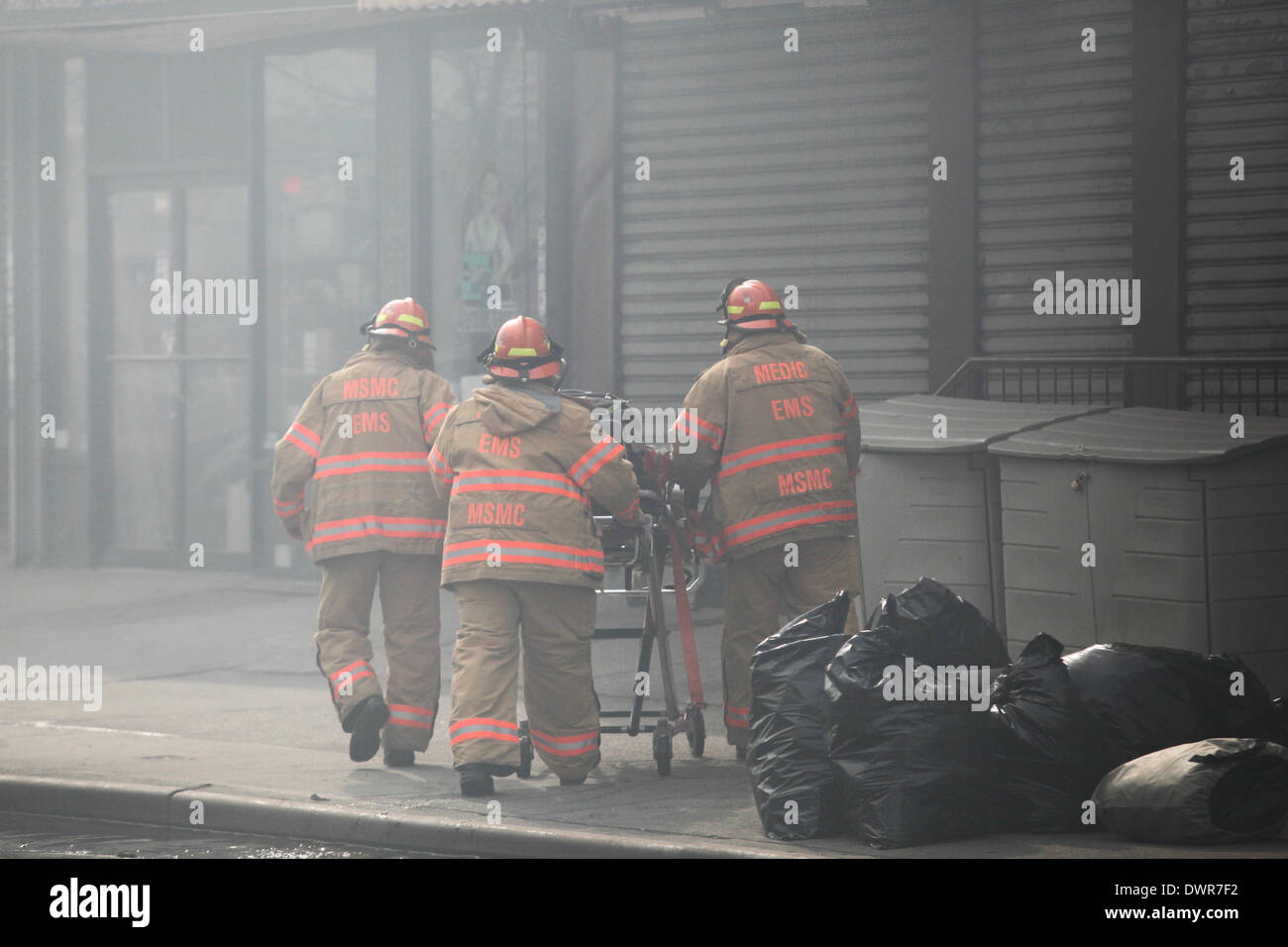 Harlem, New York City. 12 March 2014. EMS crew heads towards the four alarm fire on 116th Street in Harlem Credit:  Cal Vornberger/Alamy Live News Stock Photo