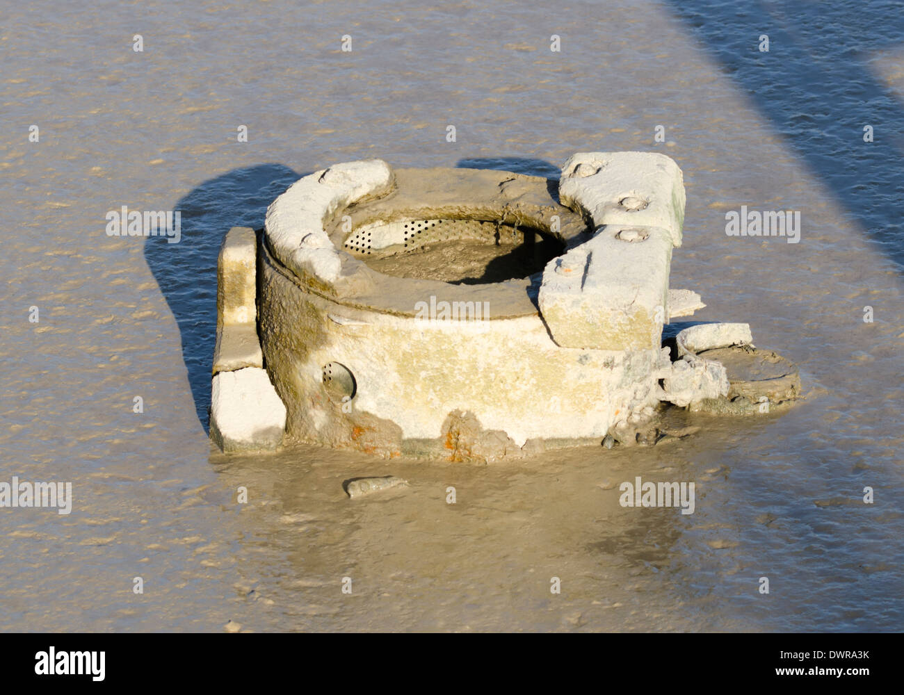 Old composting toilet from a boat, stuck in some mud. Stock Photo