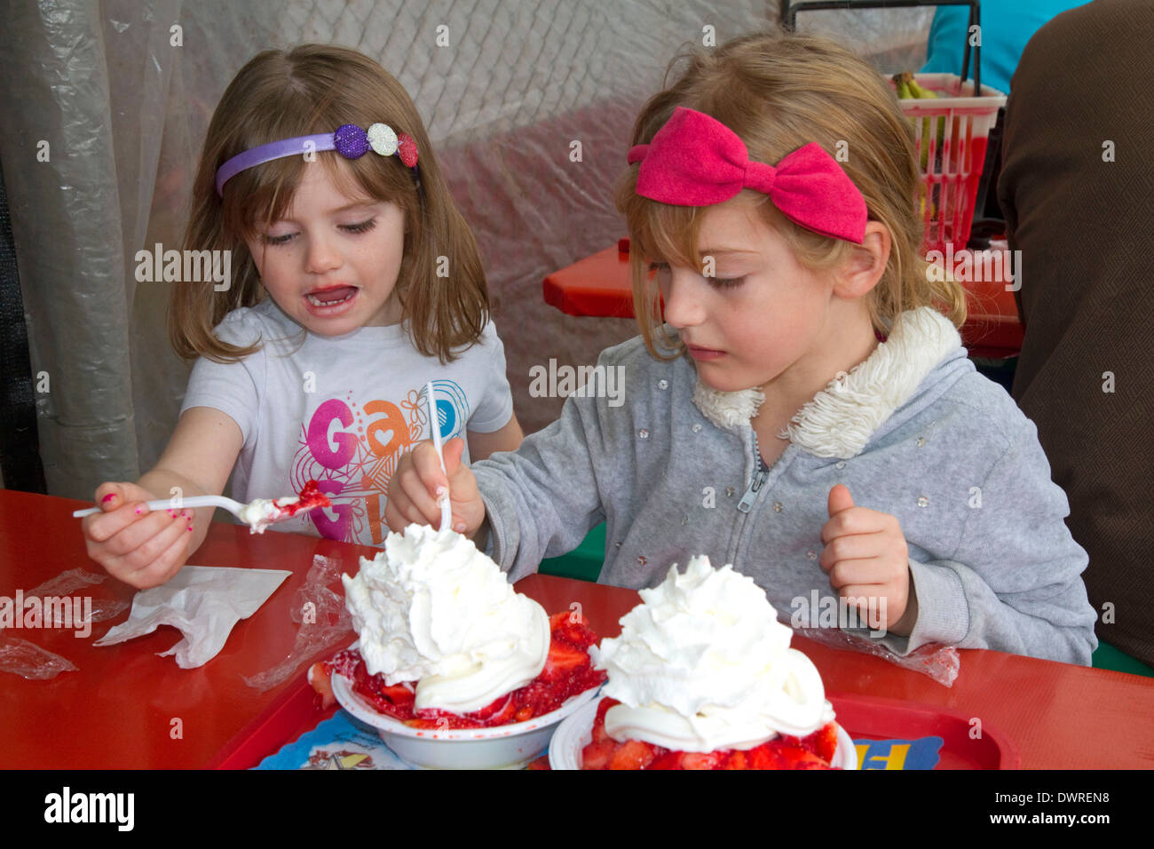 Sisters eating strawberry shortcake at Parksdale Farm in Plant City, Florida, USA. MR Stock Photo