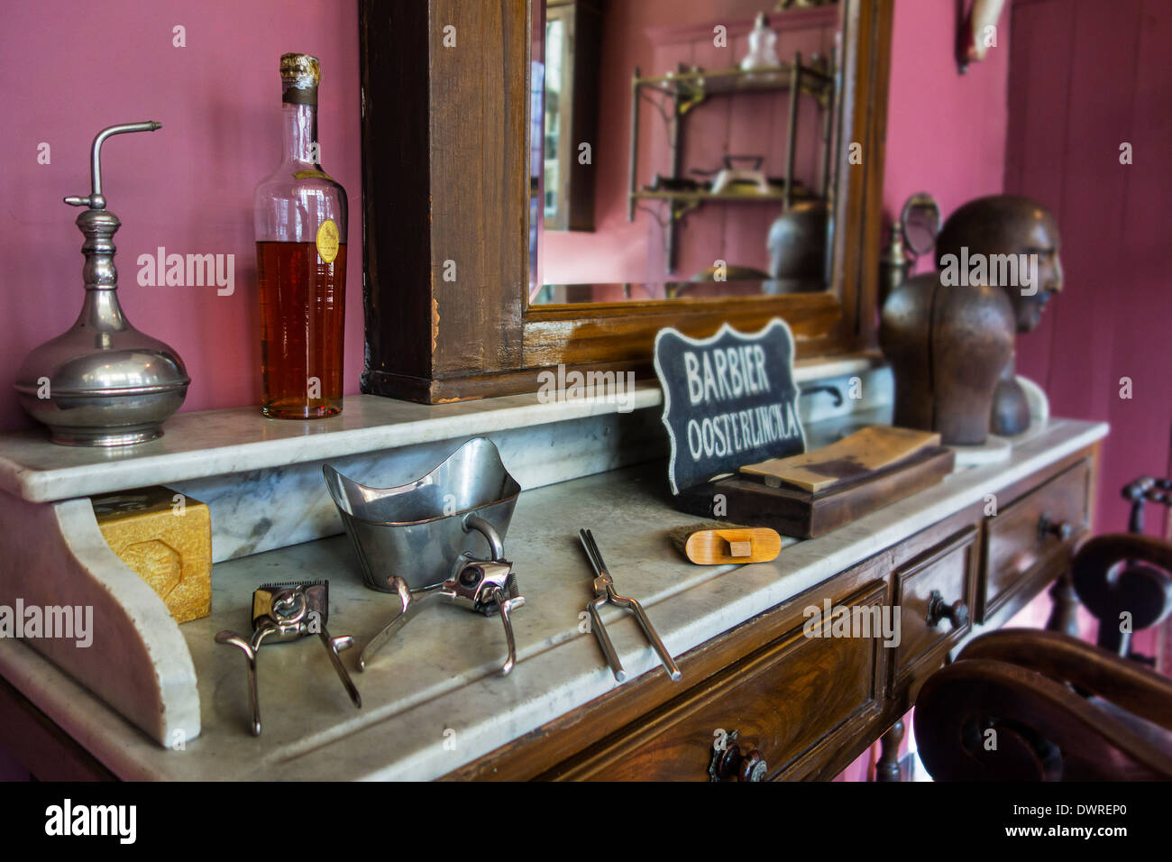 Interior of old barber's shop showing manual beard clippers of early 20th century at the House of Alijn museum, Ghent, Belgium Stock Photo