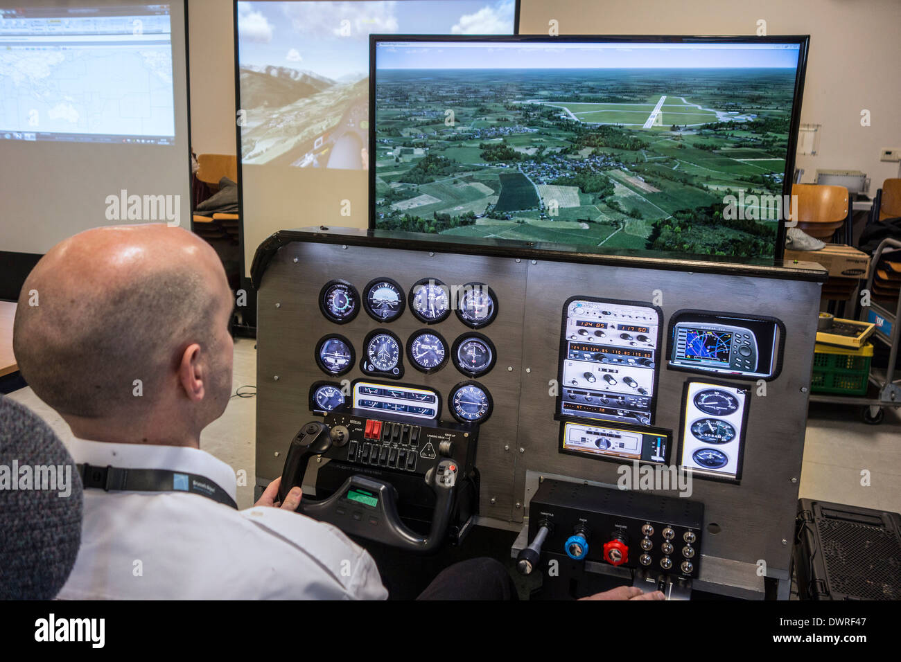 Man navigating virtual airplane in amateur flight simulator on home computer Stock Photo