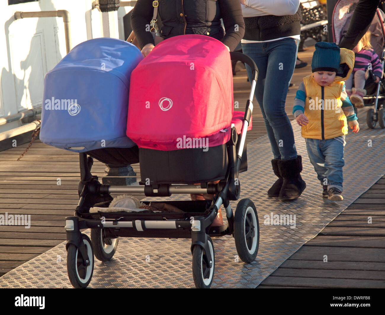 A pram for twins on Brighton Pier Stock Photo