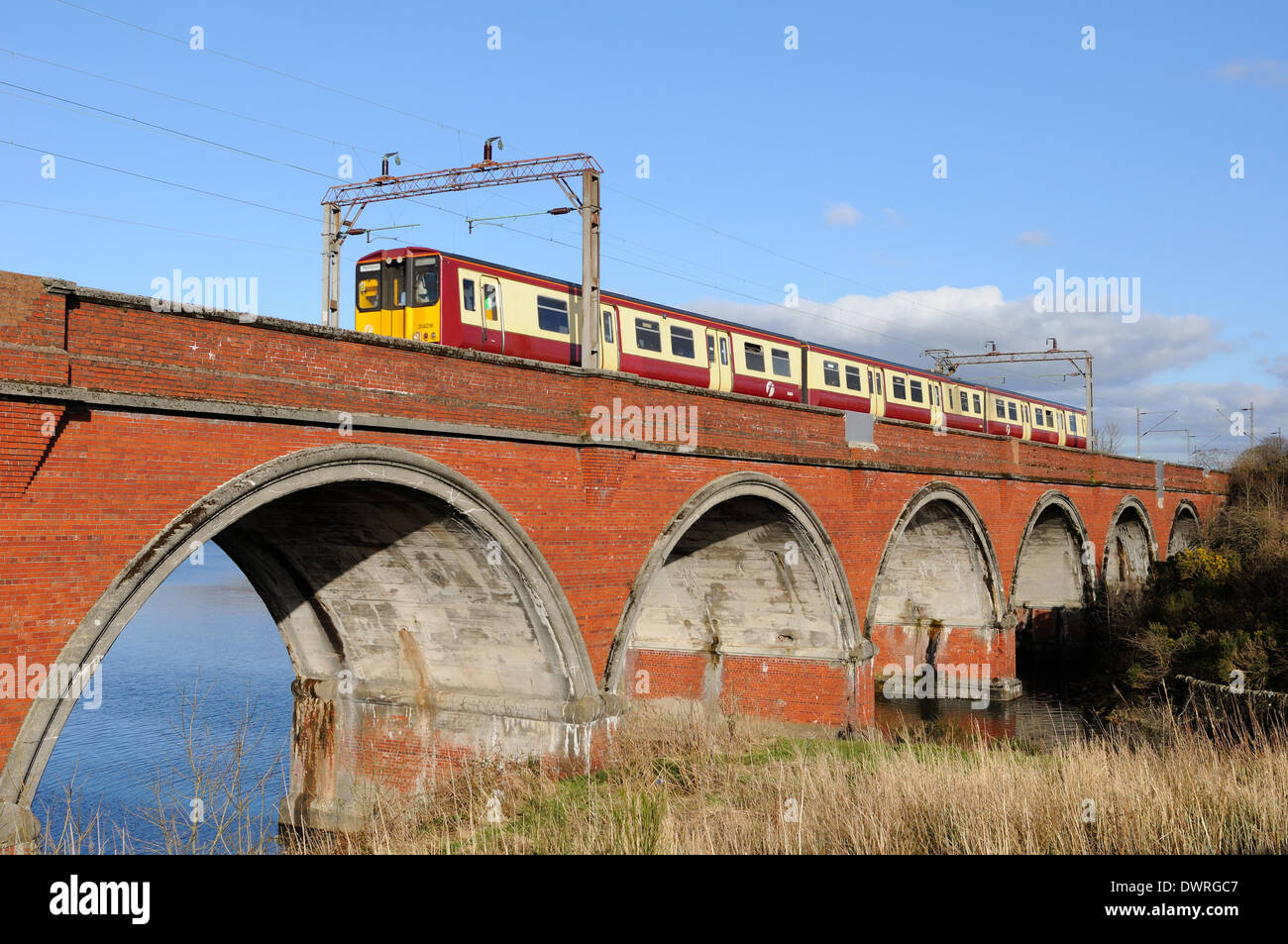 Network rail viaduct with electrified line and First train Stock Photo