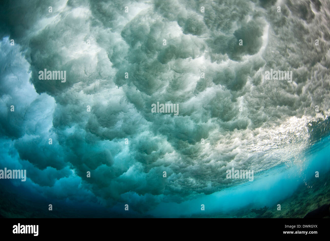 Unique underwater view of a wave breaking over a reef in the Maldives Stock Photo Alamy