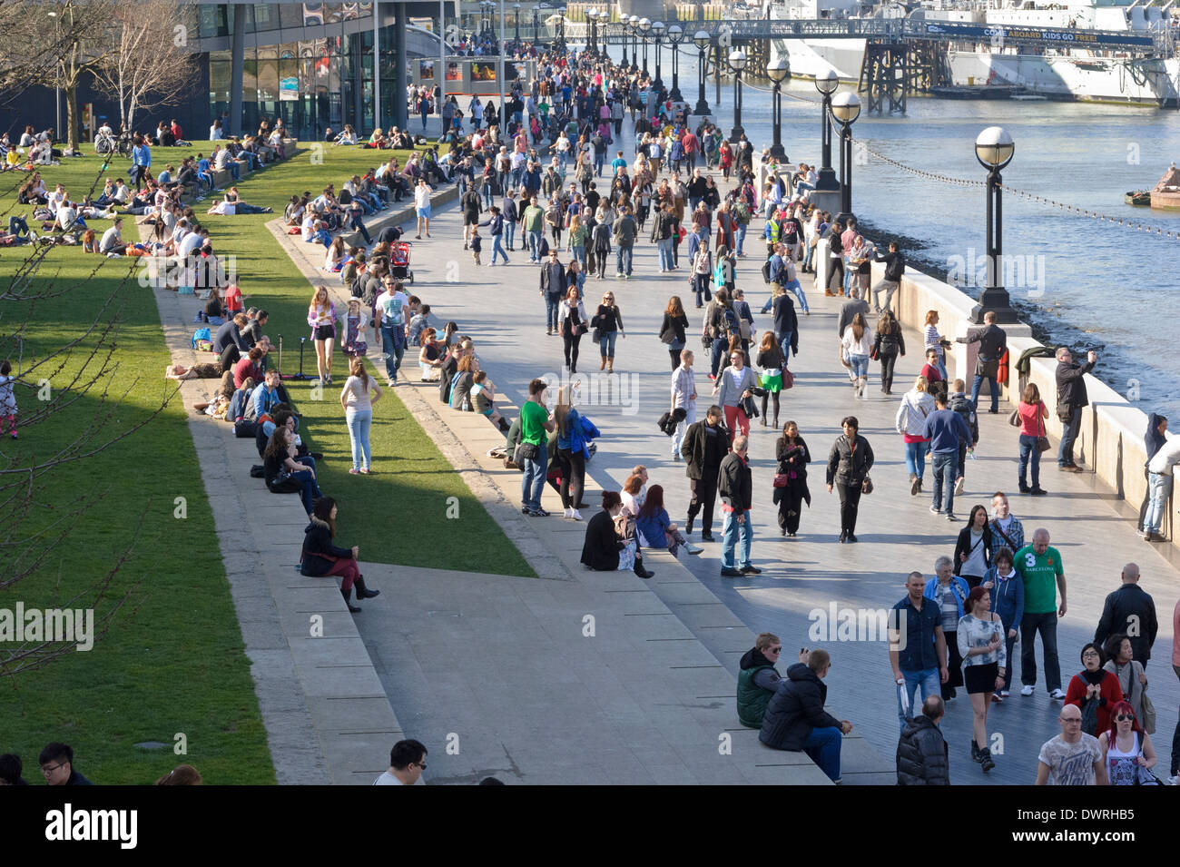 People enjoying a hot sunny day by City Hall in London, England, United Kingdom. Stock Photo