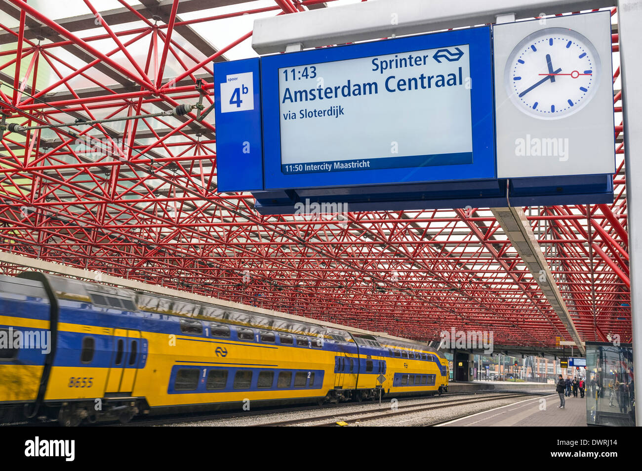 Railway station at Zandaam, near Amsterdam Centraal, Netherlands with a train passing through Stock Photo