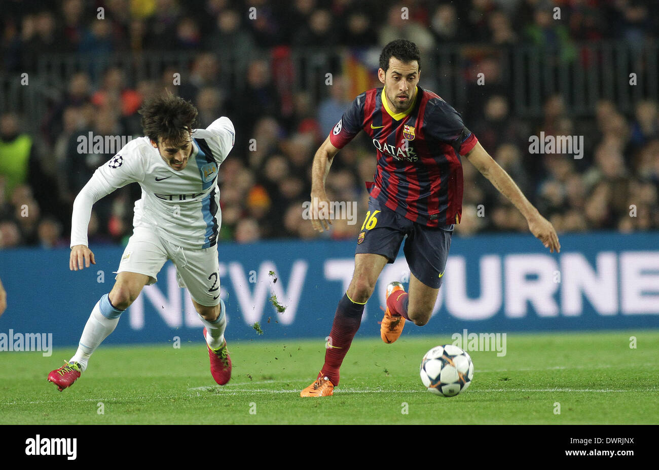 Barcelona, Spain. 12th Mar, 2014. Sergio Busquets cuts inside Silva during the Champions league game between Barcelona and Manchester City from the Nou Camp Stadium. Credit:  Action Plus Sports/Alamy Live News Stock Photo