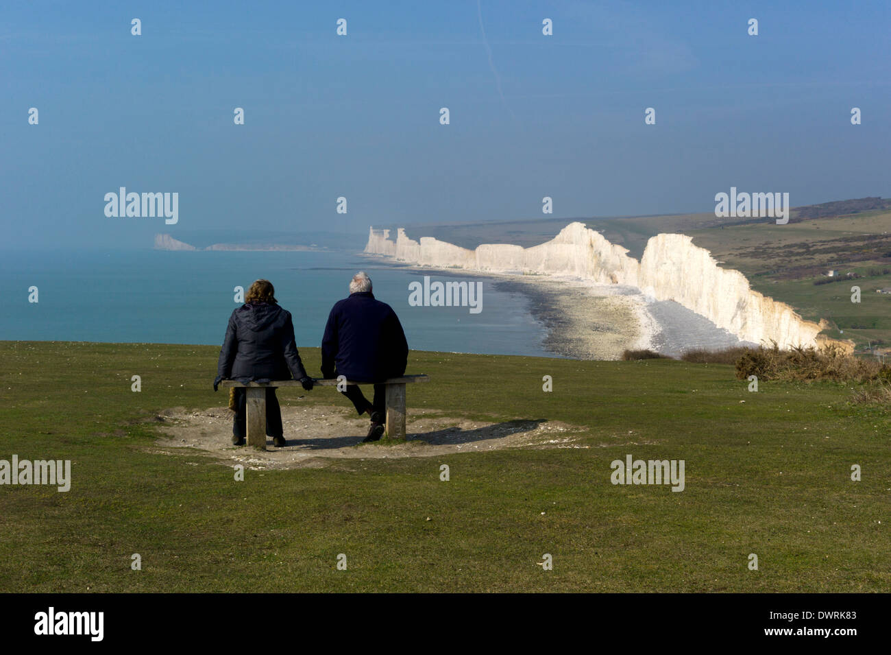 Admiring the view from the hill above Birling Gap towards Sevens Sisters and Seaford Head on the Sussex coast, England Stock Photo